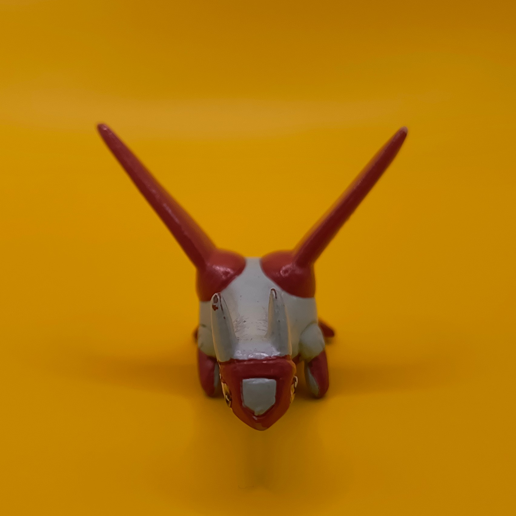 Rød og hvid Latias Pokémon-figur fra Bandai med stempler på vingerne.